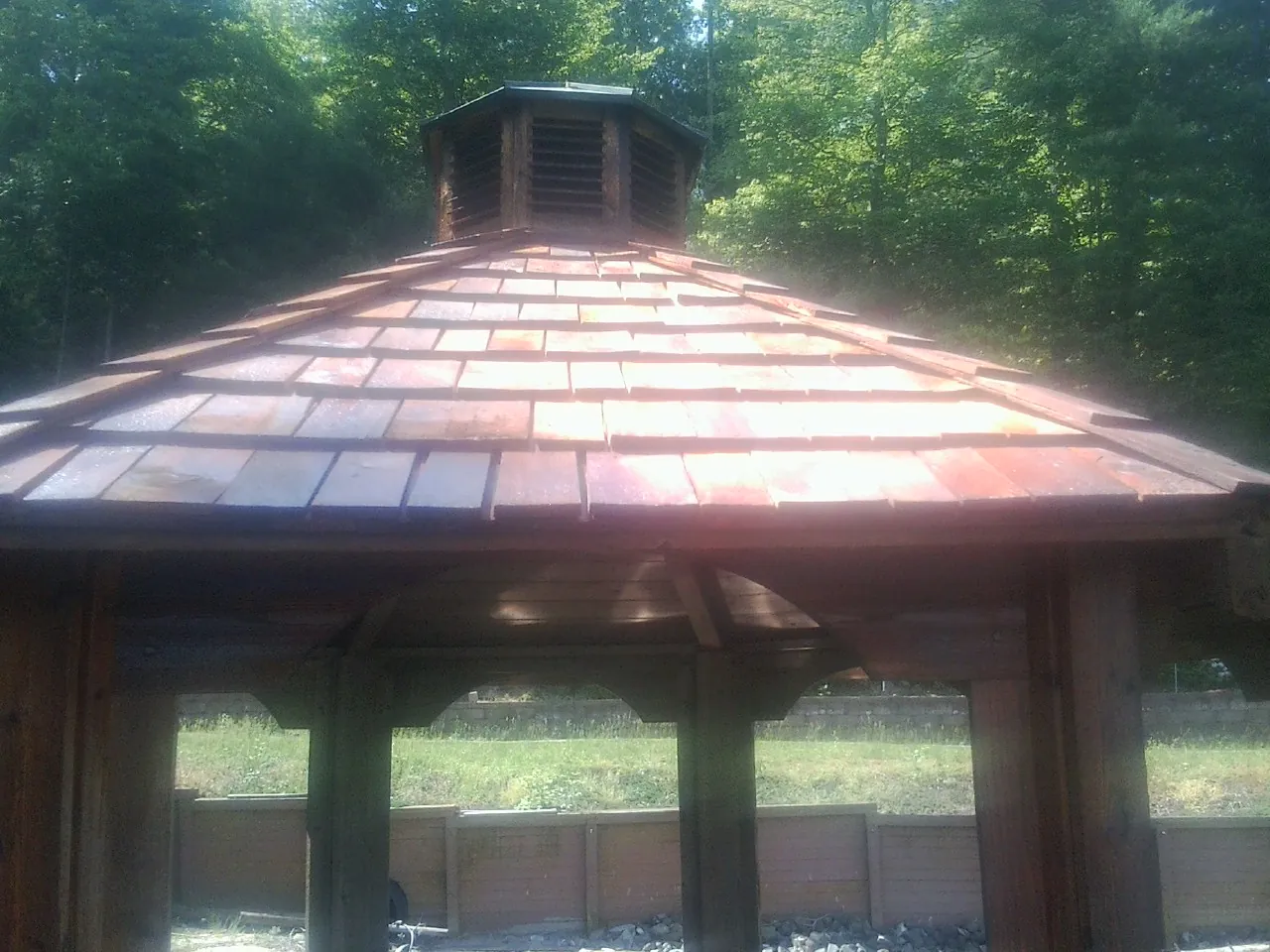 New cedar shake roof and cupola on a lakeside gazebo in Melrose
